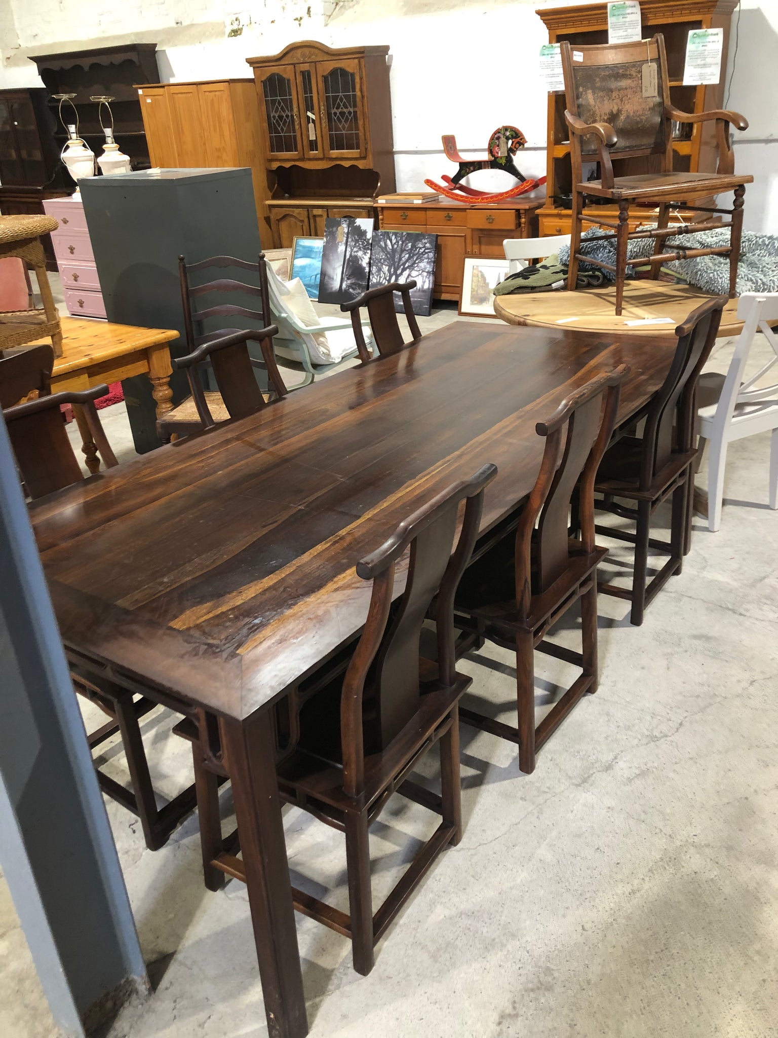 Large six seater dark wooden dining table and chairs