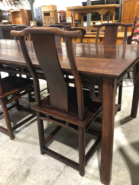Large six seater dark wooden dining table and chairs